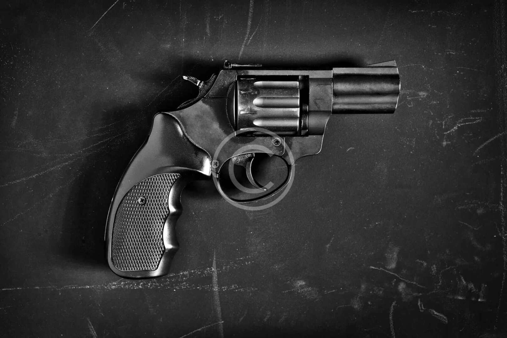 A revolver on a black background.